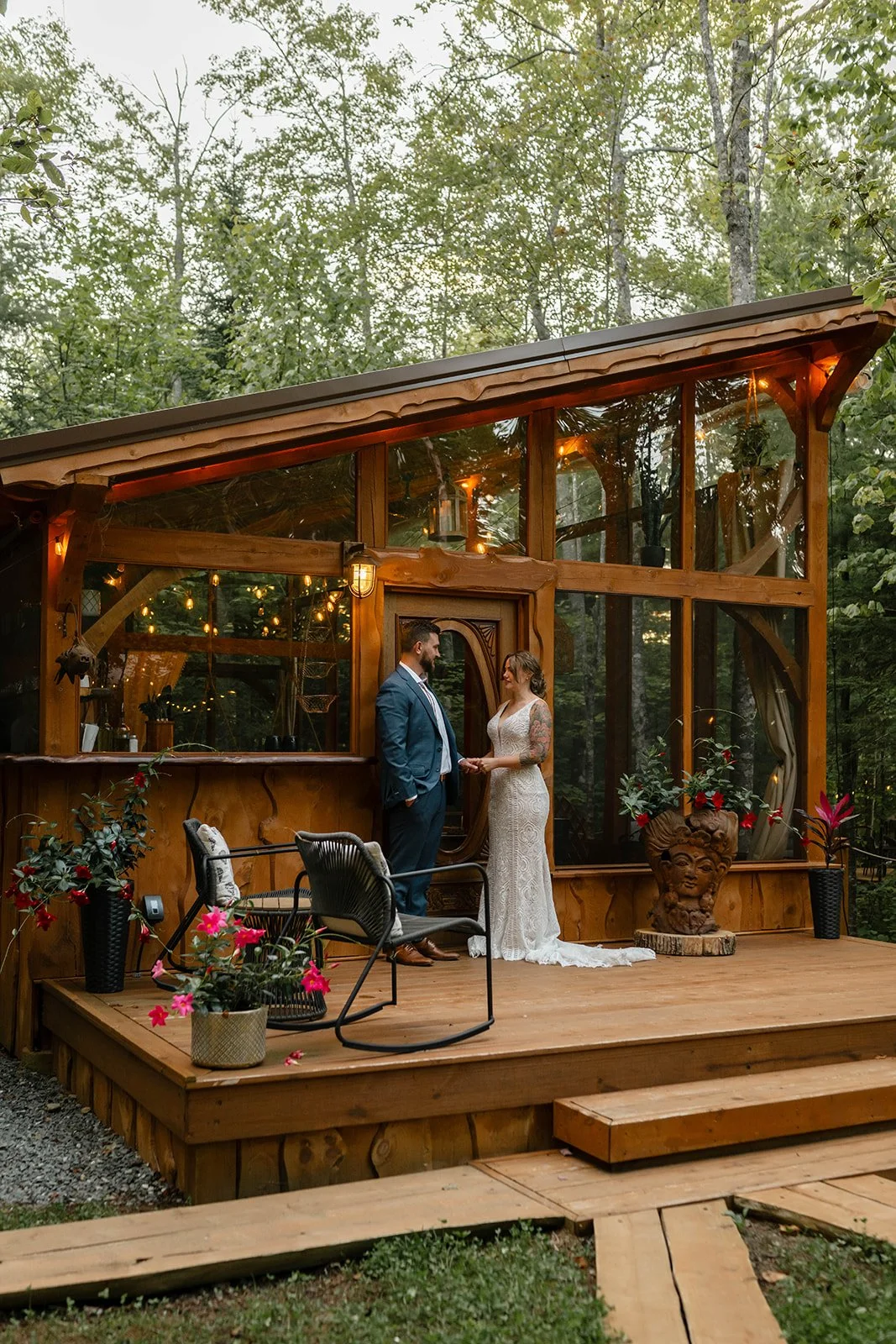 bride and groom in front of the cabin during their maine elopement