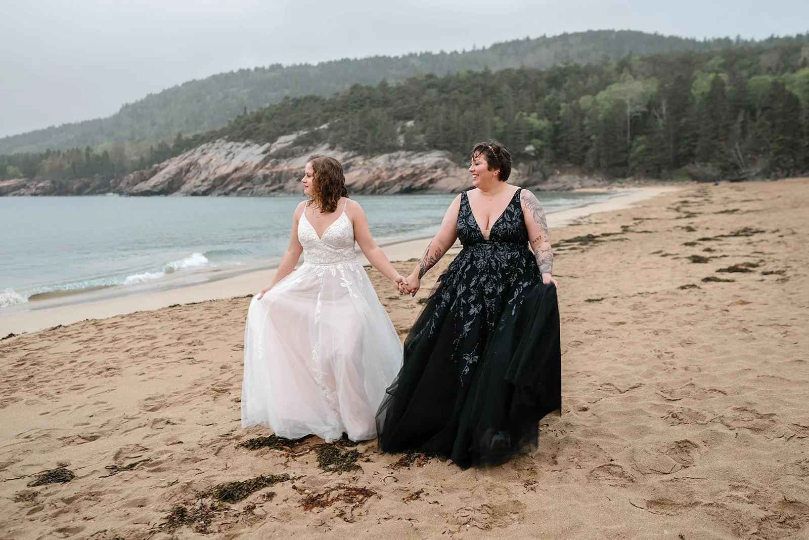 playful lesbian coastal elopement photos at sand beach in acadia national park