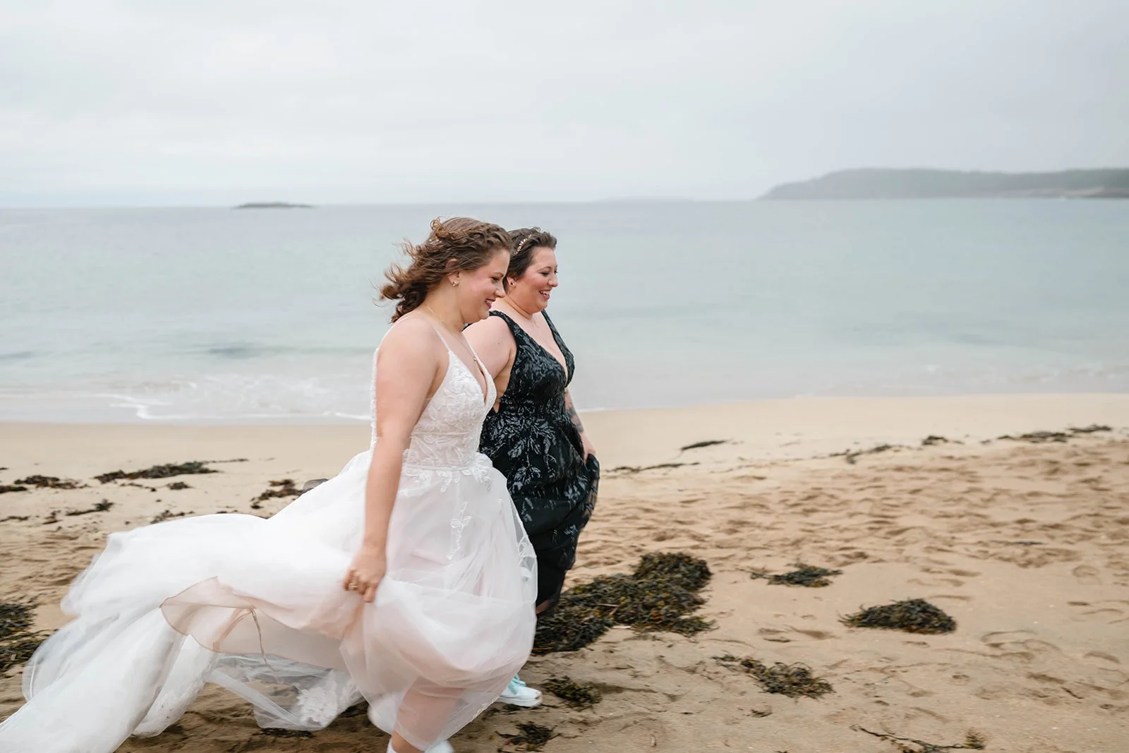 playful lesbian coastal elopement photos at sand beach in acadia national park