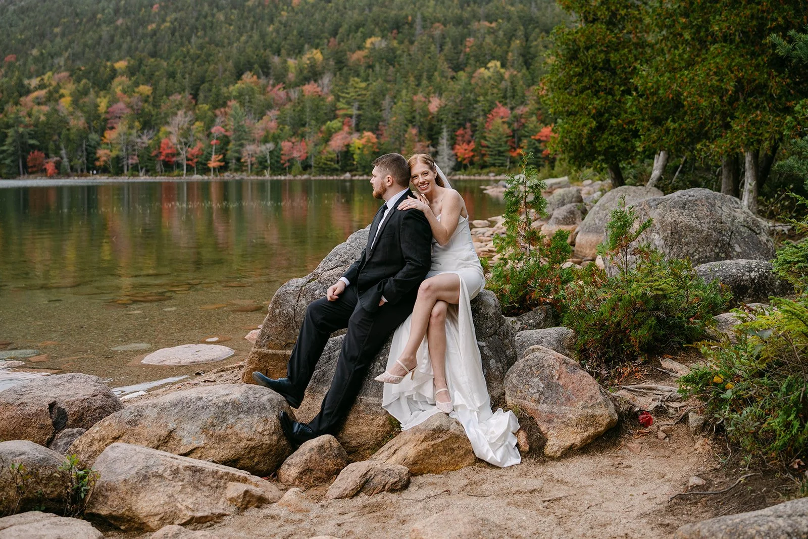 bride and groom sitting on rocks during their acadia, maine elopement