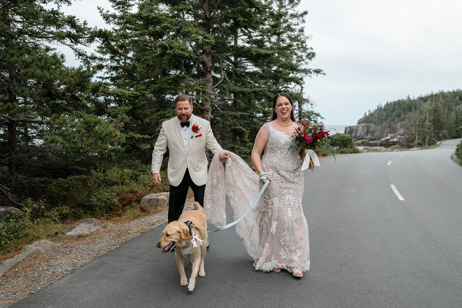 fun elopement couple walking their dog in acadia national park