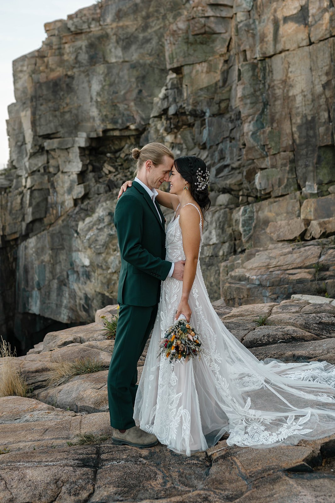 snuggly elopement couple at otter cliff overlook in acadia national park