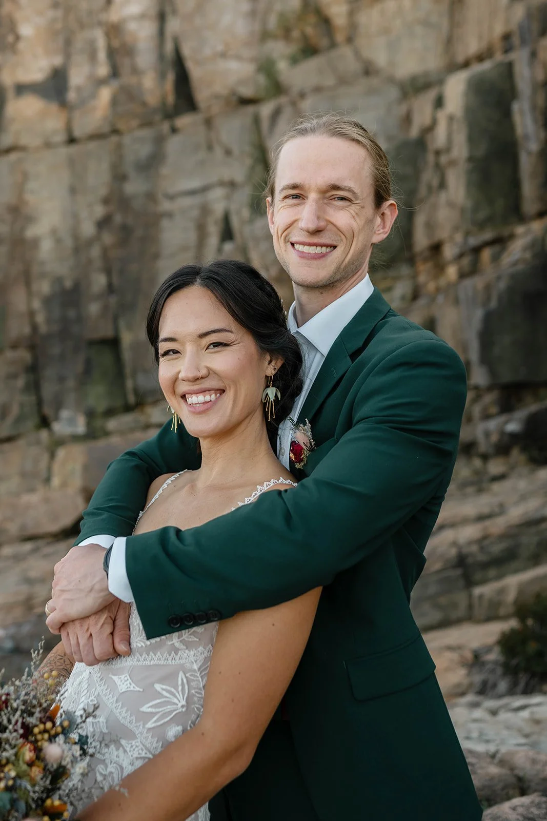 snuggly elopement couple at otter cliff overlook in acadia national park