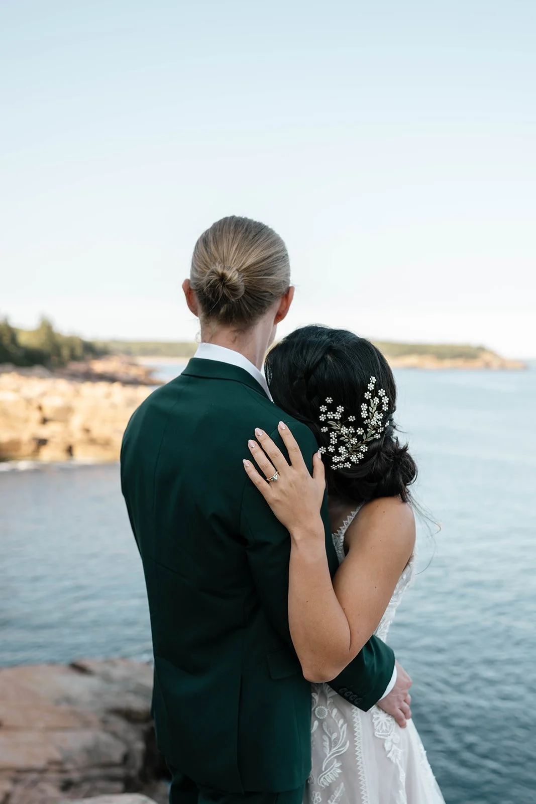bride and groom hugging at monument cove during their acadia elopement