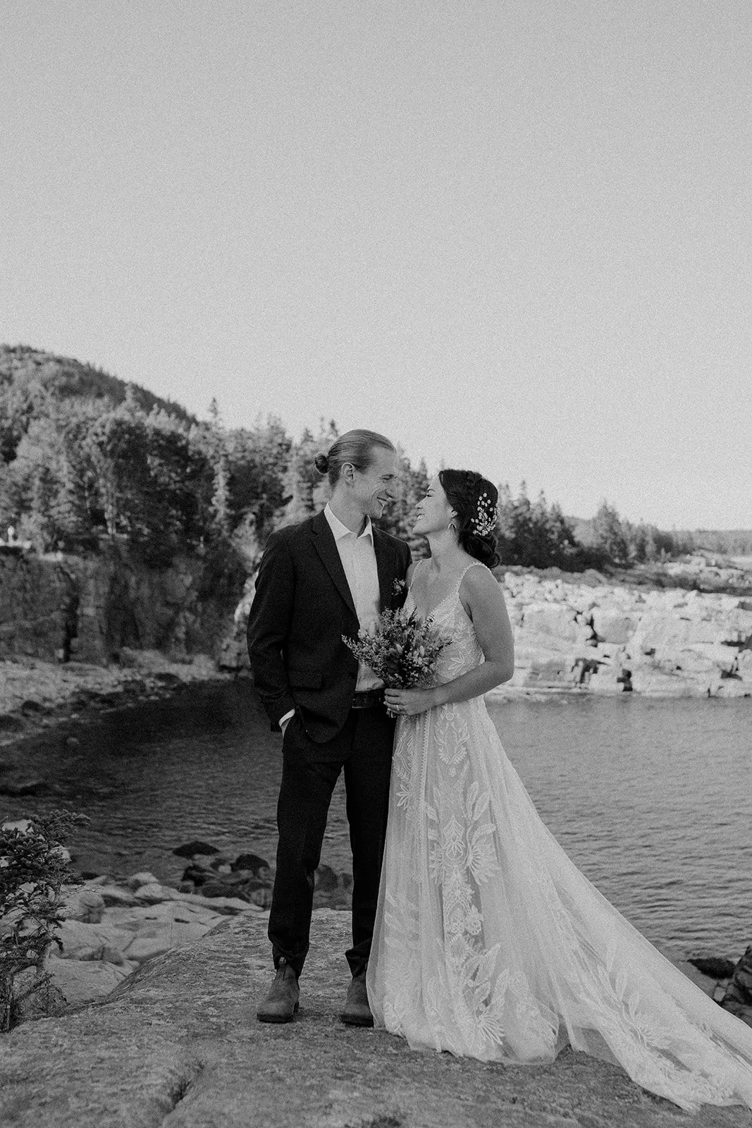 bride and groom hugging at monument cove during their acadia elopement