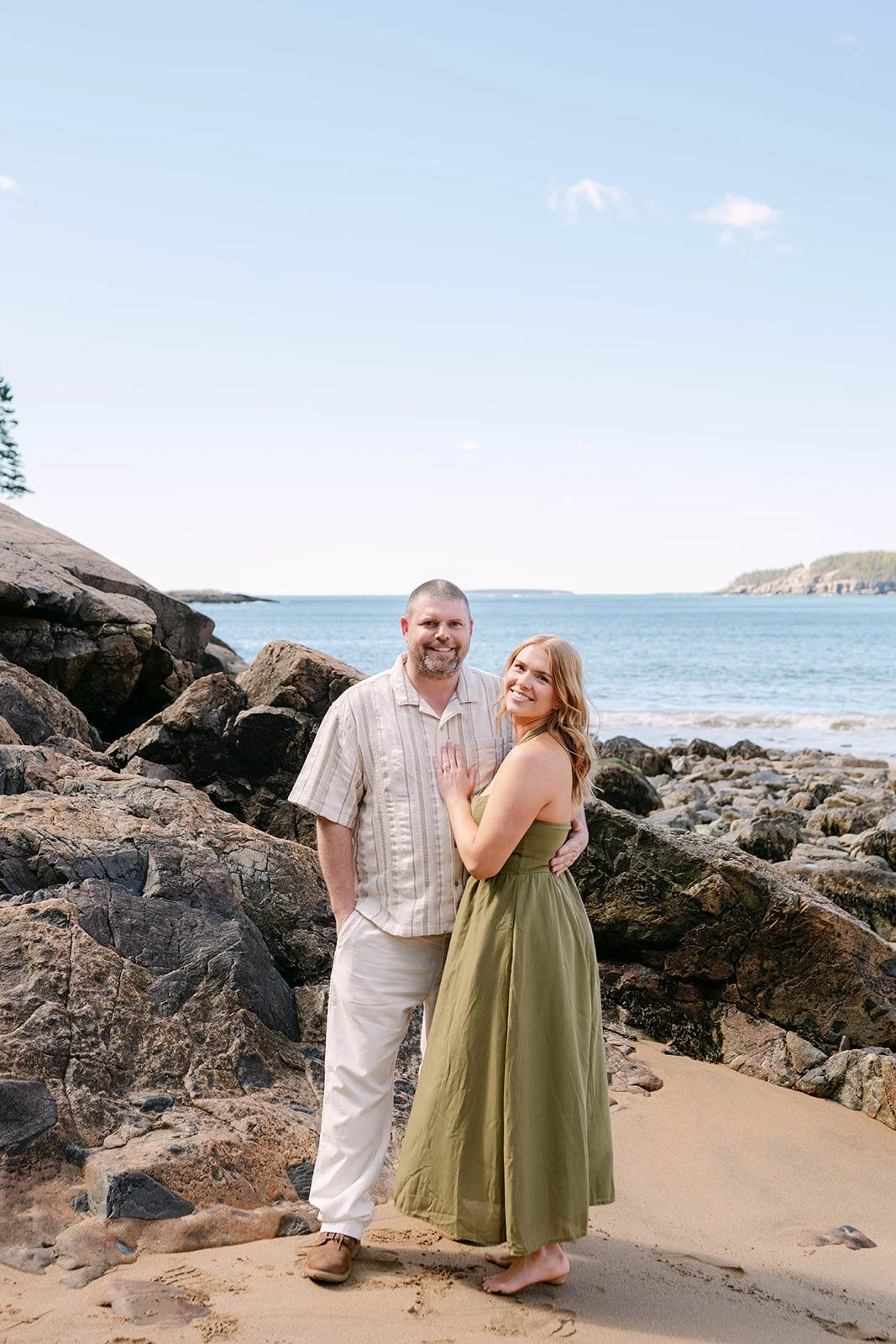 playful couple during their acadia national park engagement photos session at sand beach