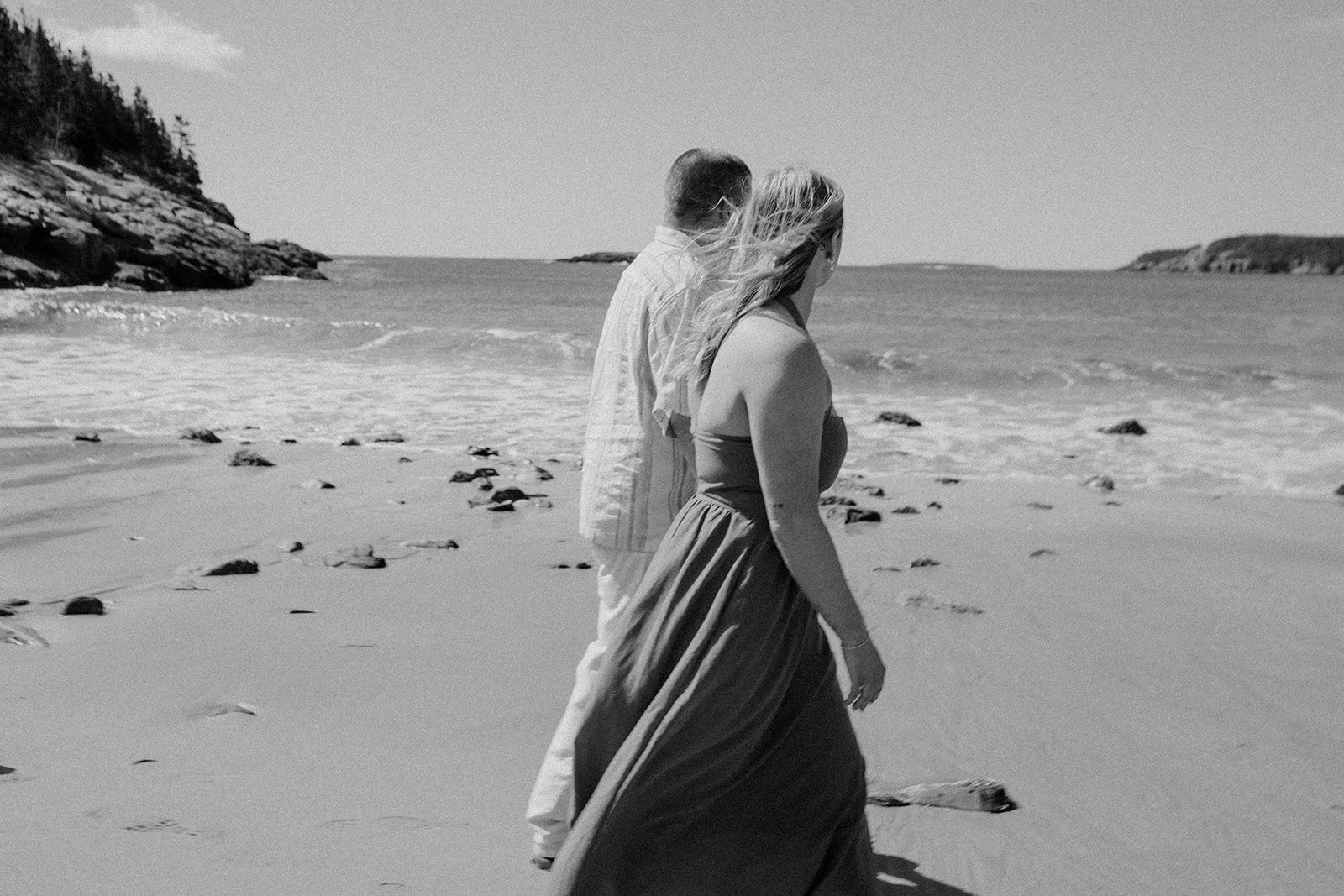 playful couple during their acadia national park engagement photos session at sand beach