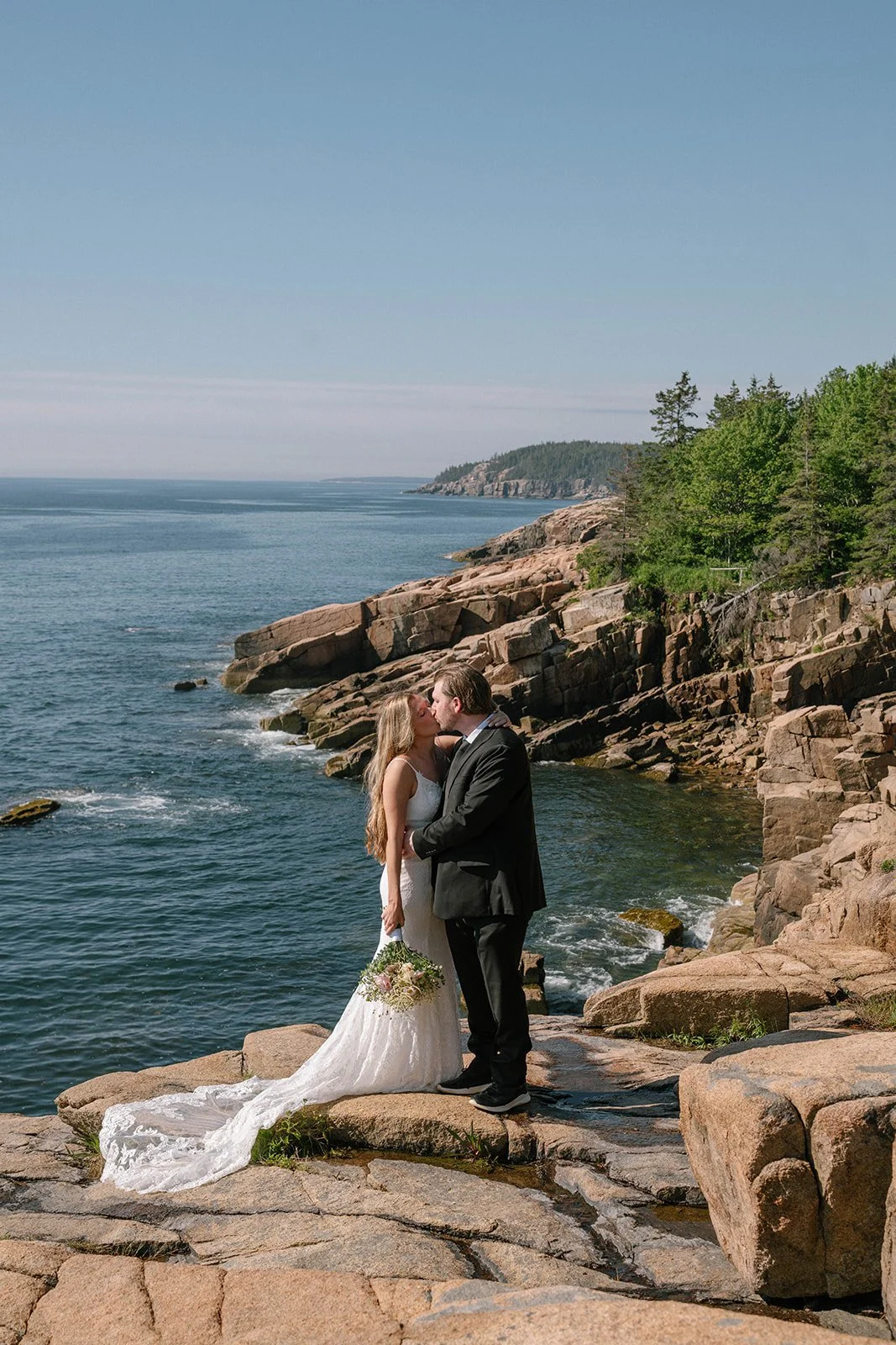 bride and groom on a coastal cliff in acadia national park during their elopement