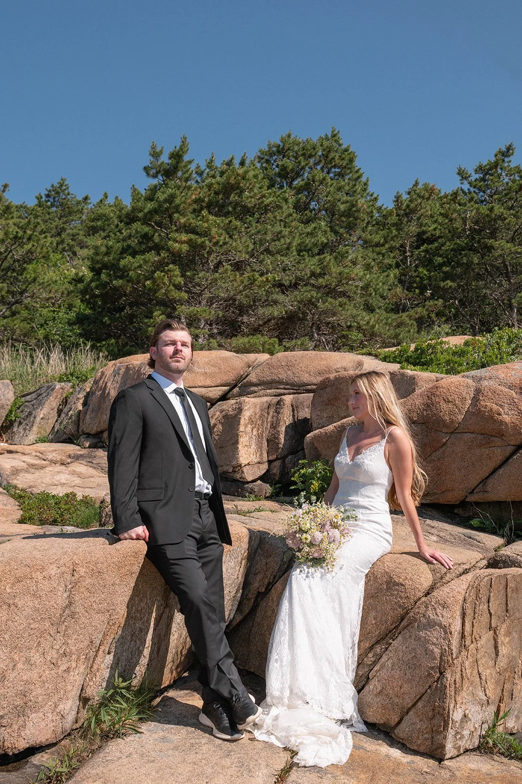 bride and groom on a coastal cliff in acadia national park during their elopement