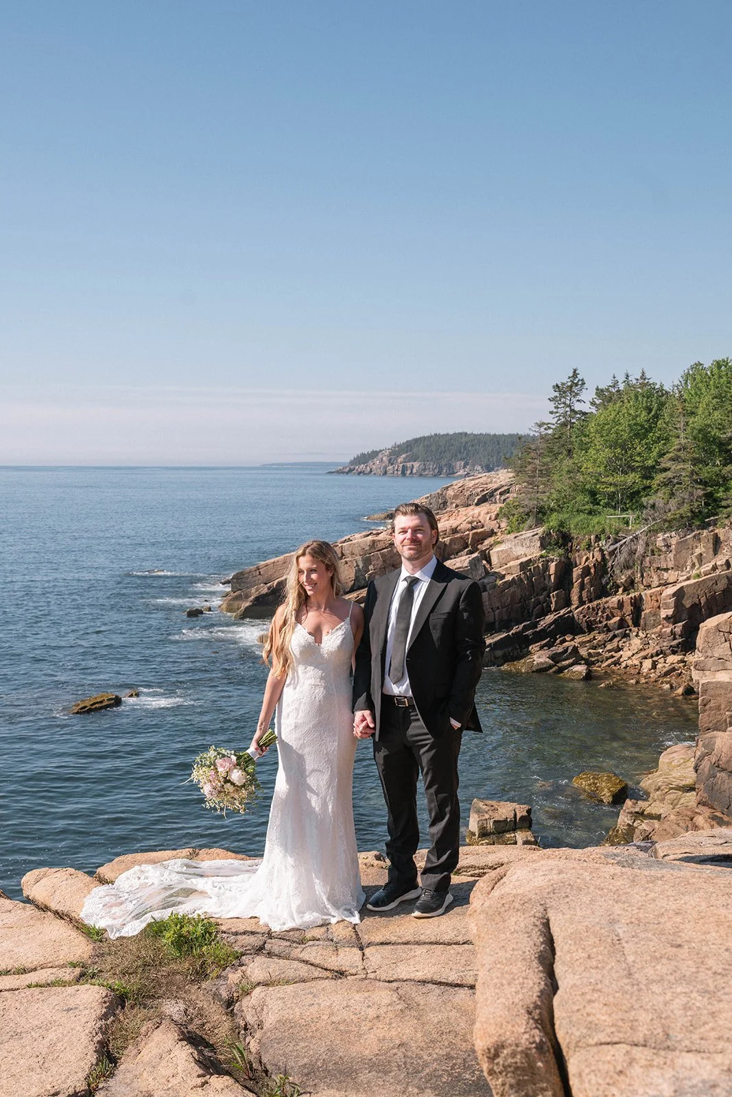 bride and groom on a coastal cliff in acadia national park during their elopement