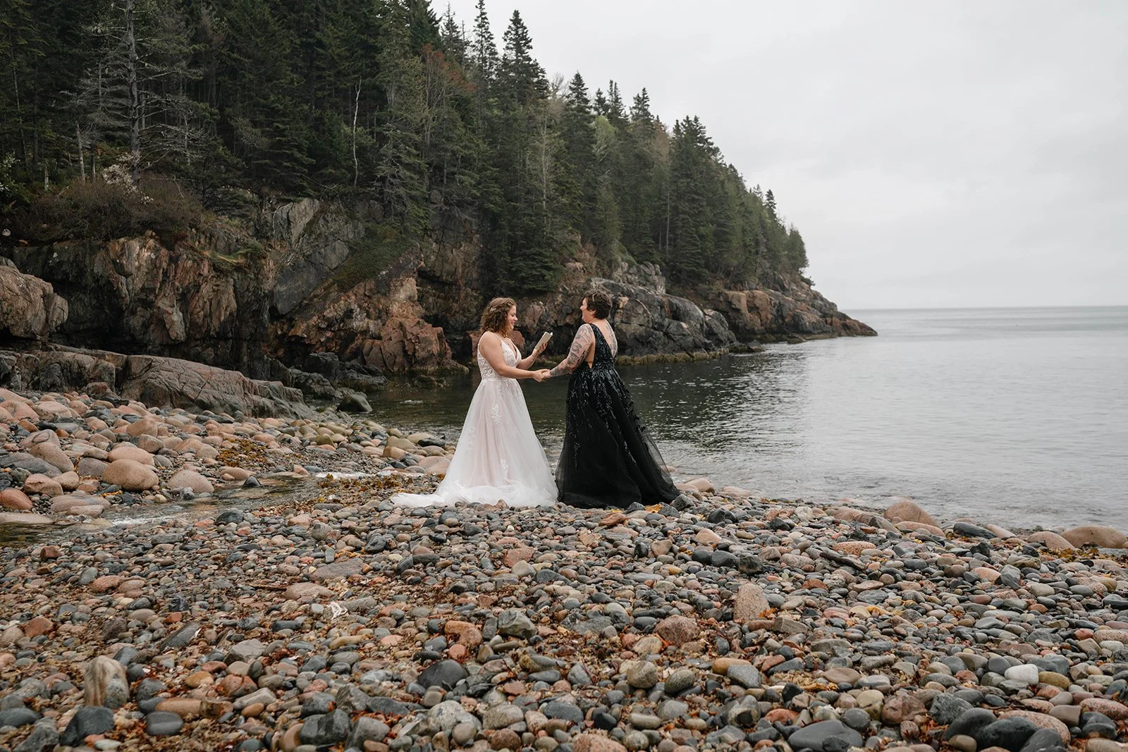 brides exchanging vows at hunter's beach in acadia national park