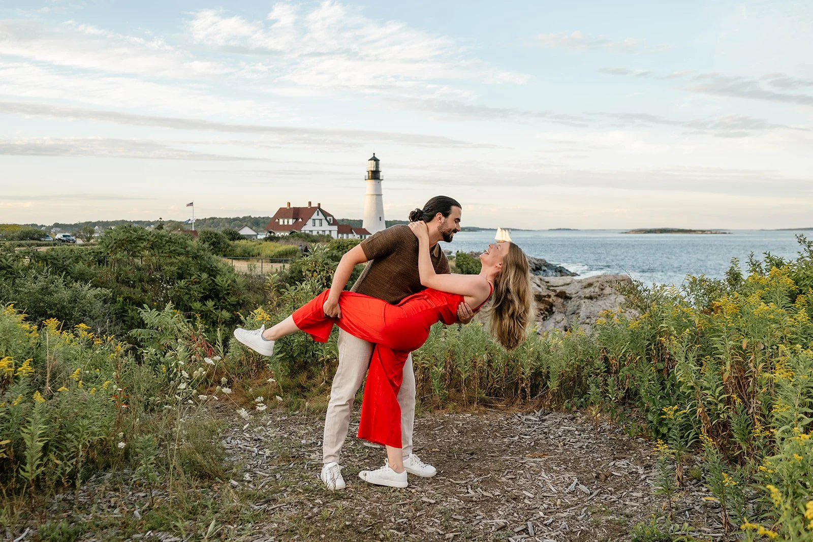 surprise proposal overlooking a lighthouse in maine