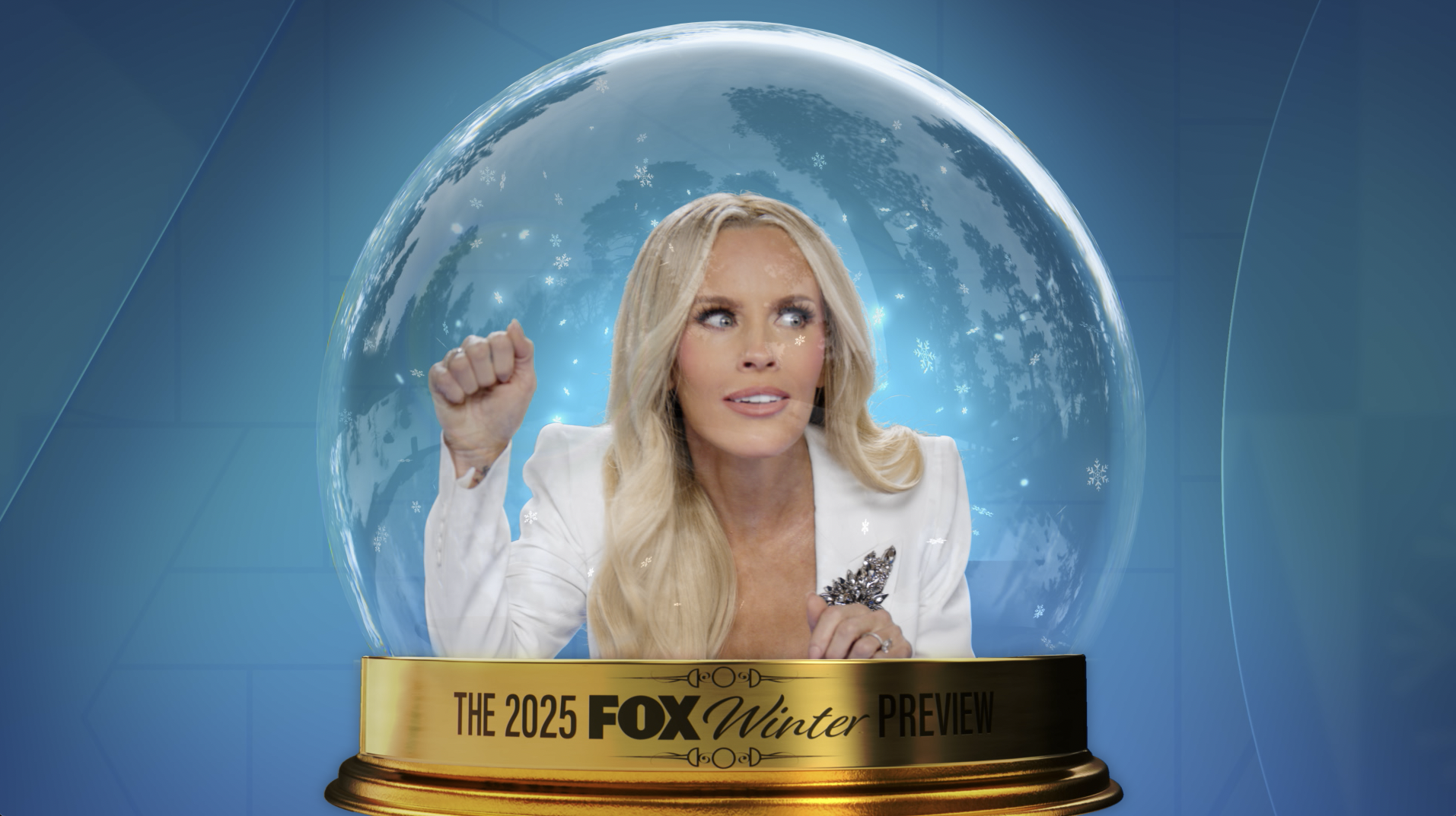 A woman with long blonde hair, wearing a white blazer, looks surprised as she presses her fist against a viewing glass. Snowflakes and a winter scene are visible behind her, with a gold banner at the bottom that reads "The 2025 FOX Winter Preview."