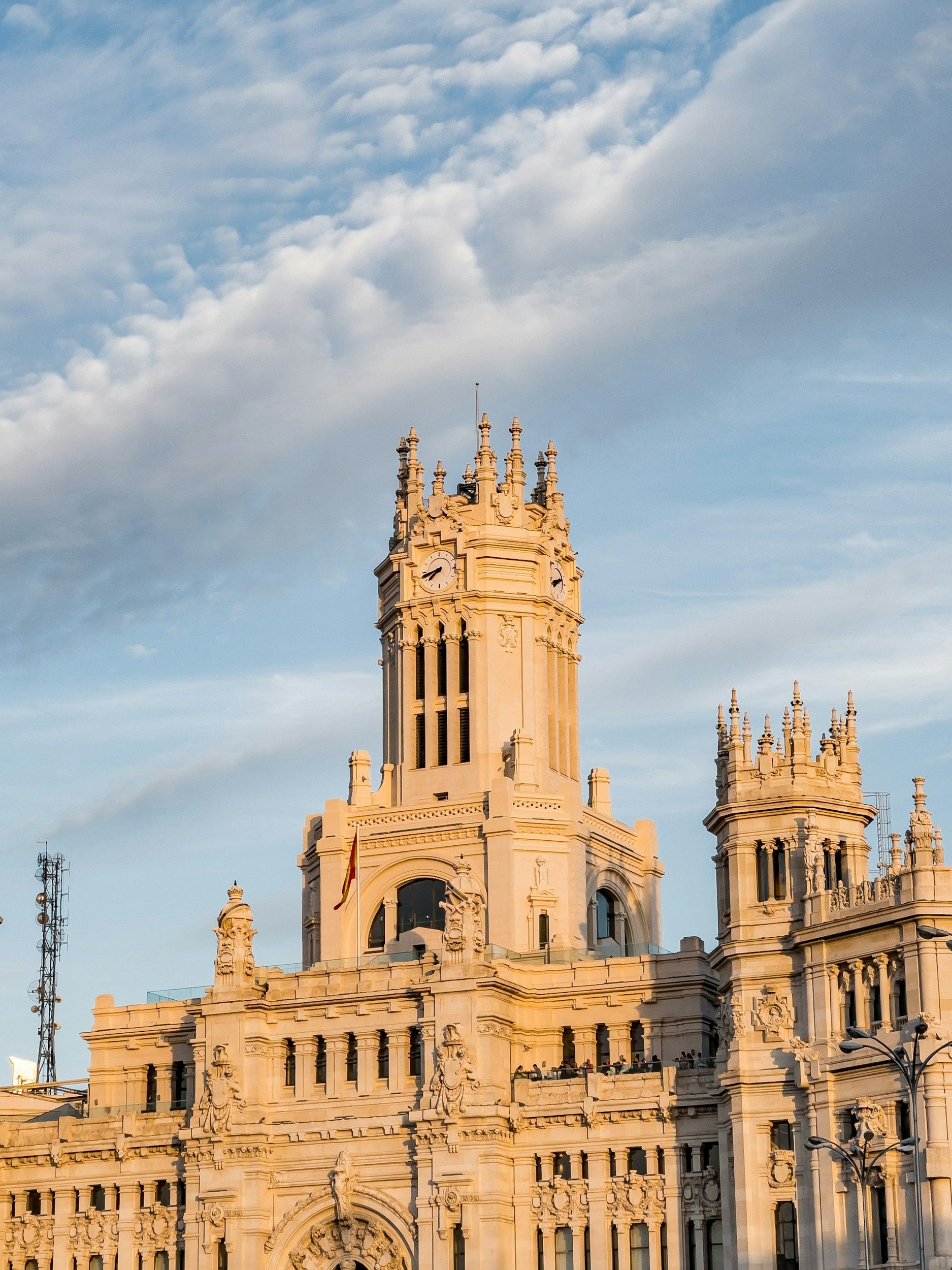 Ornate stone facade of a grand historic building in Madrid at golden hour, featured on the ALTEZA luxury travel advisory services page