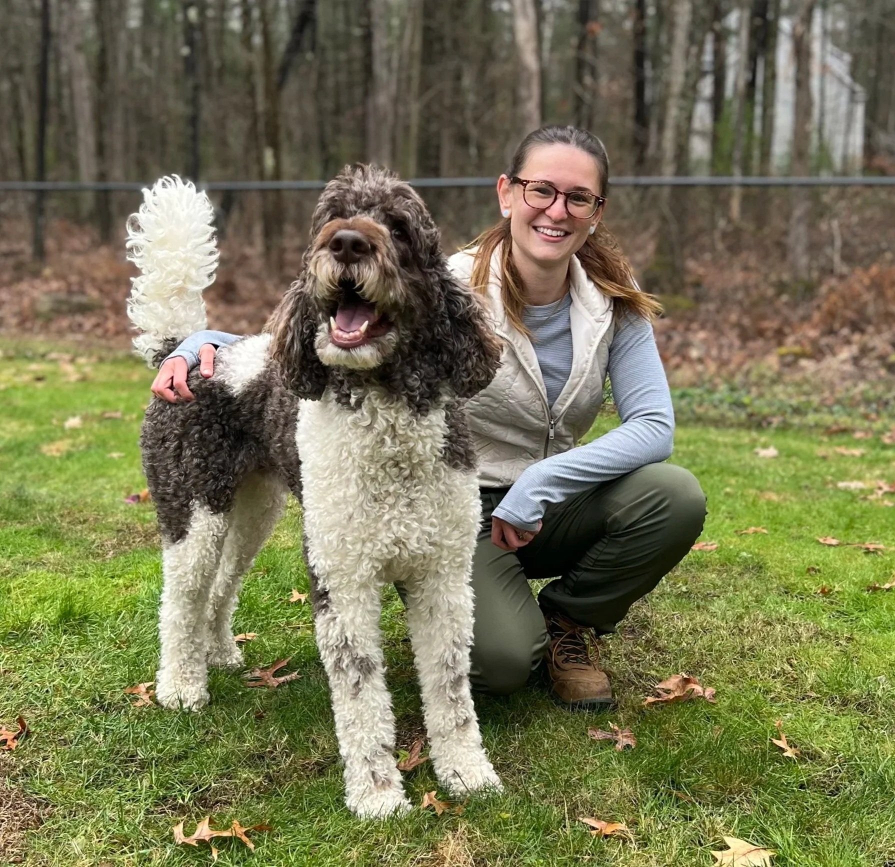 Cassie is smiling next to a dog