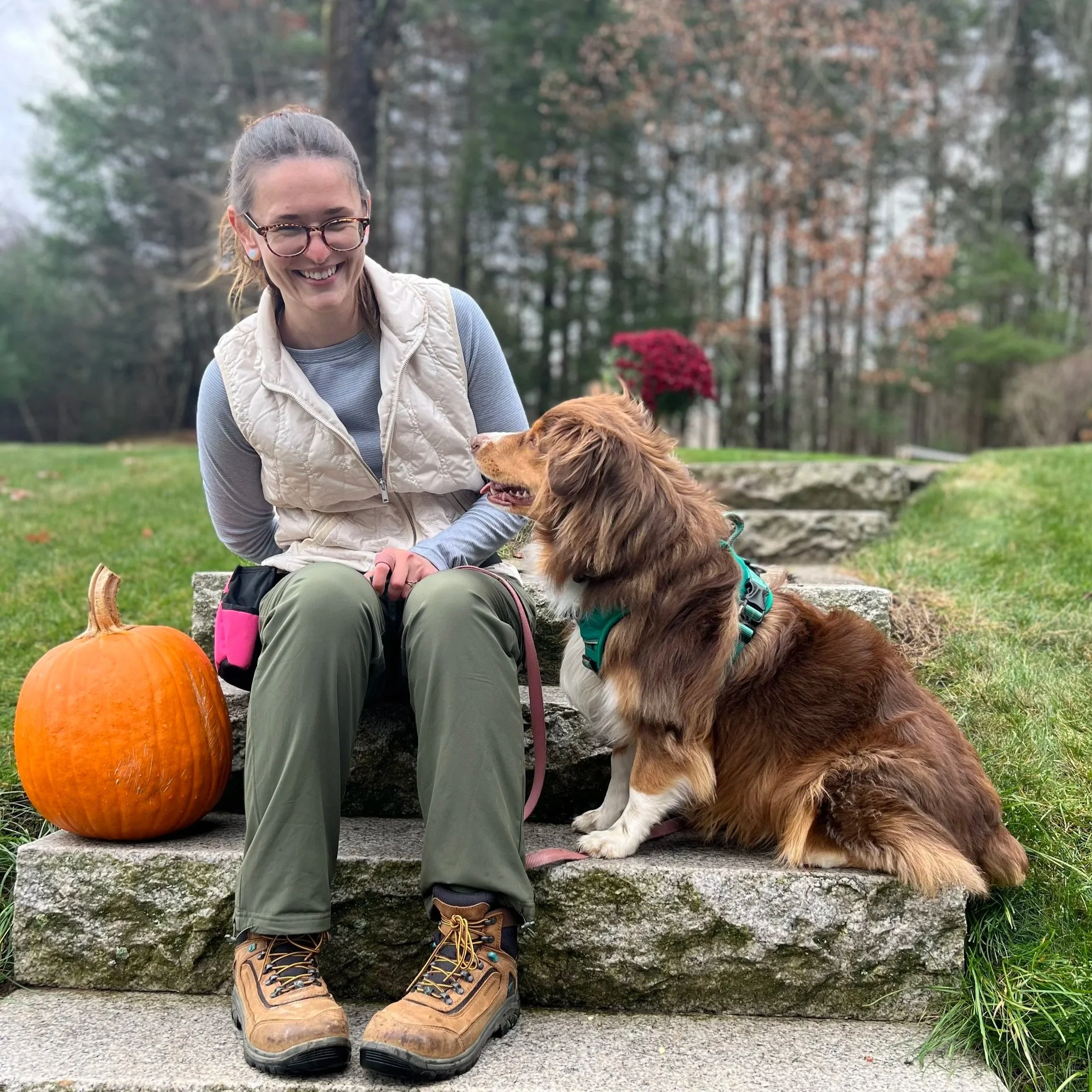 Cassie sits on some steps with her dog Penelope