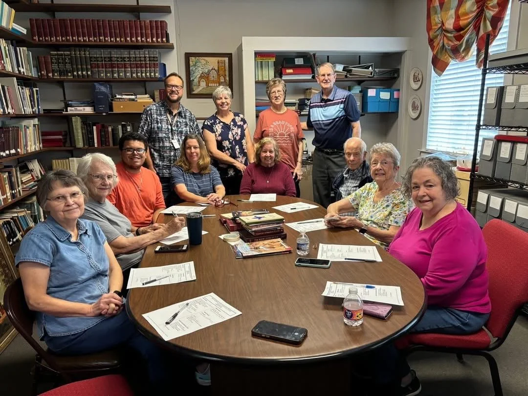 Prayer Paracletes group seated at a conference table