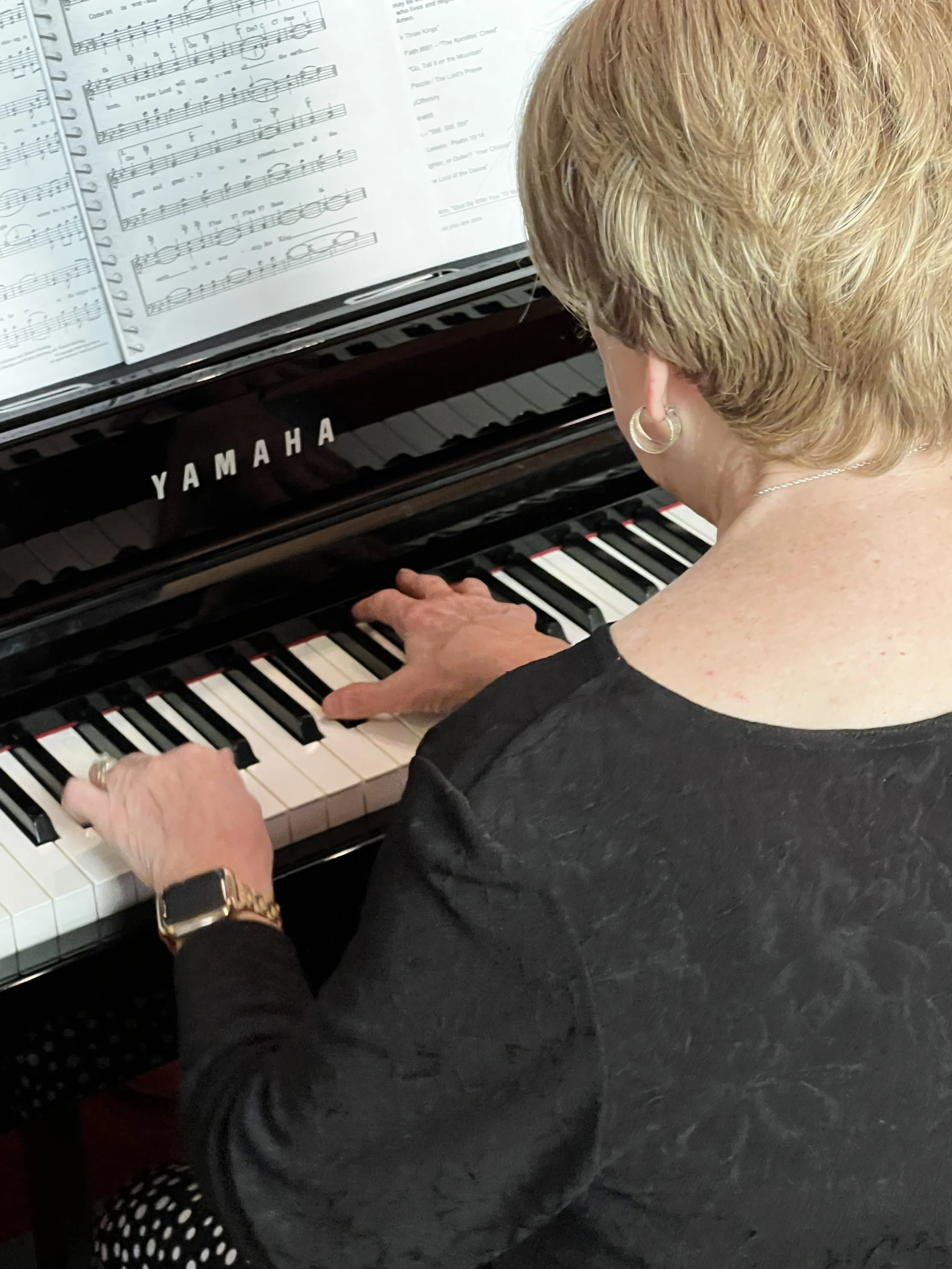 Pianist sitting at keyboard and playing