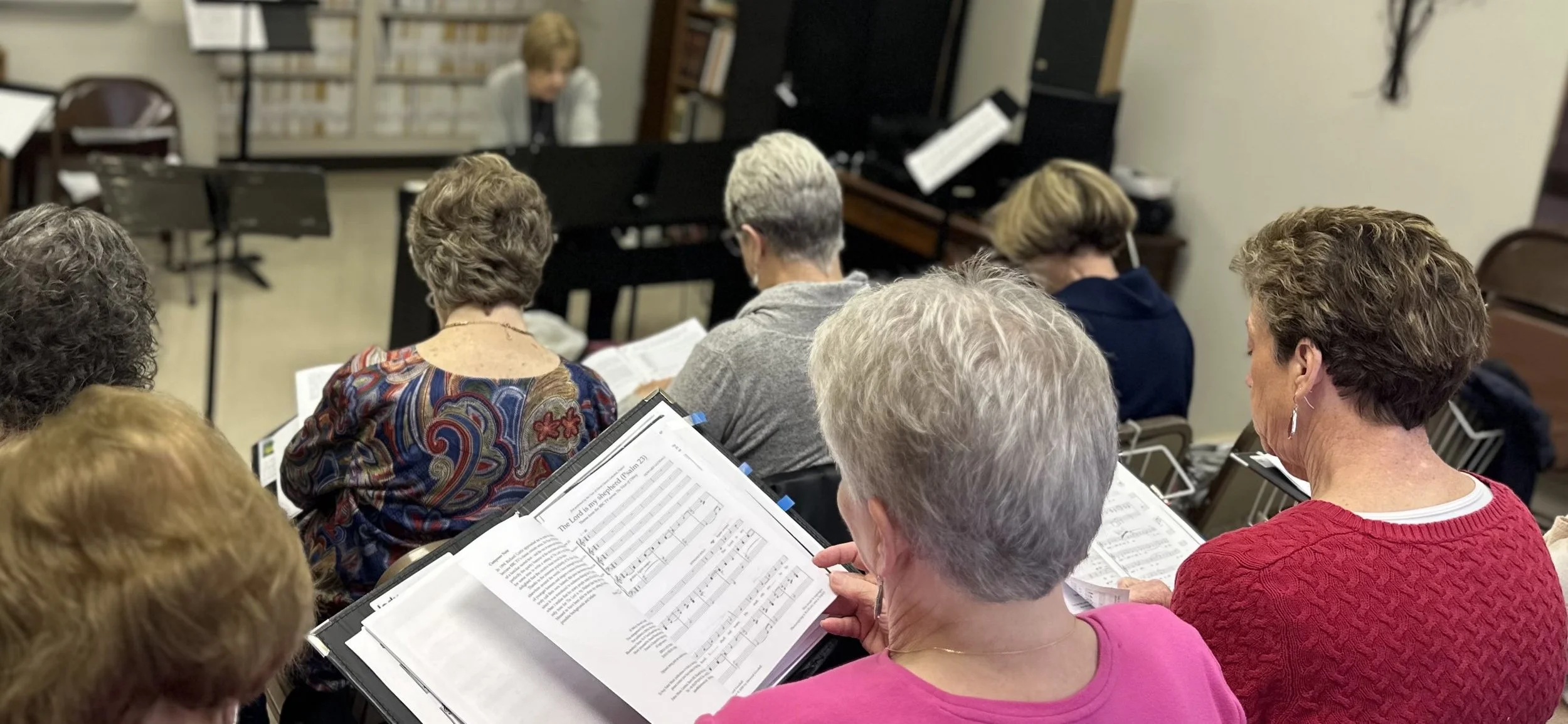 Multiple choir members at rehearsal