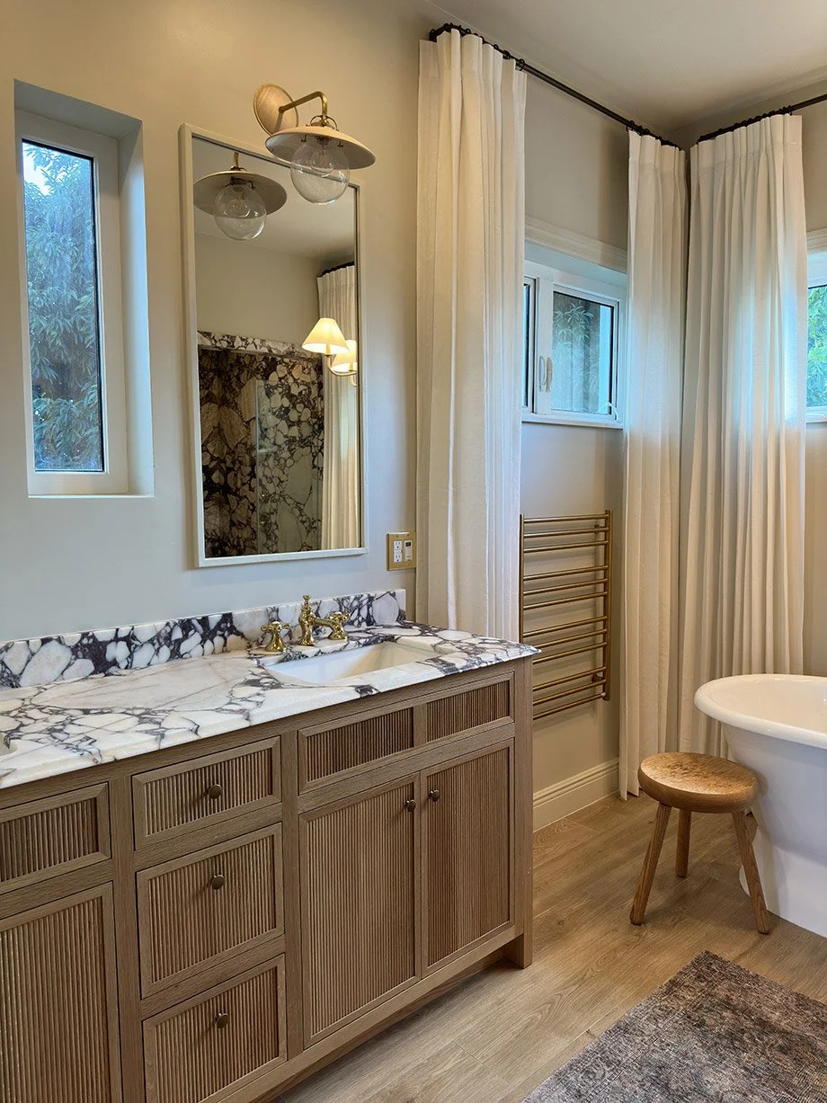 Bathroom Vanity Marble Countertop Mirror Soaker Tub Window Curtains Wood Flooring