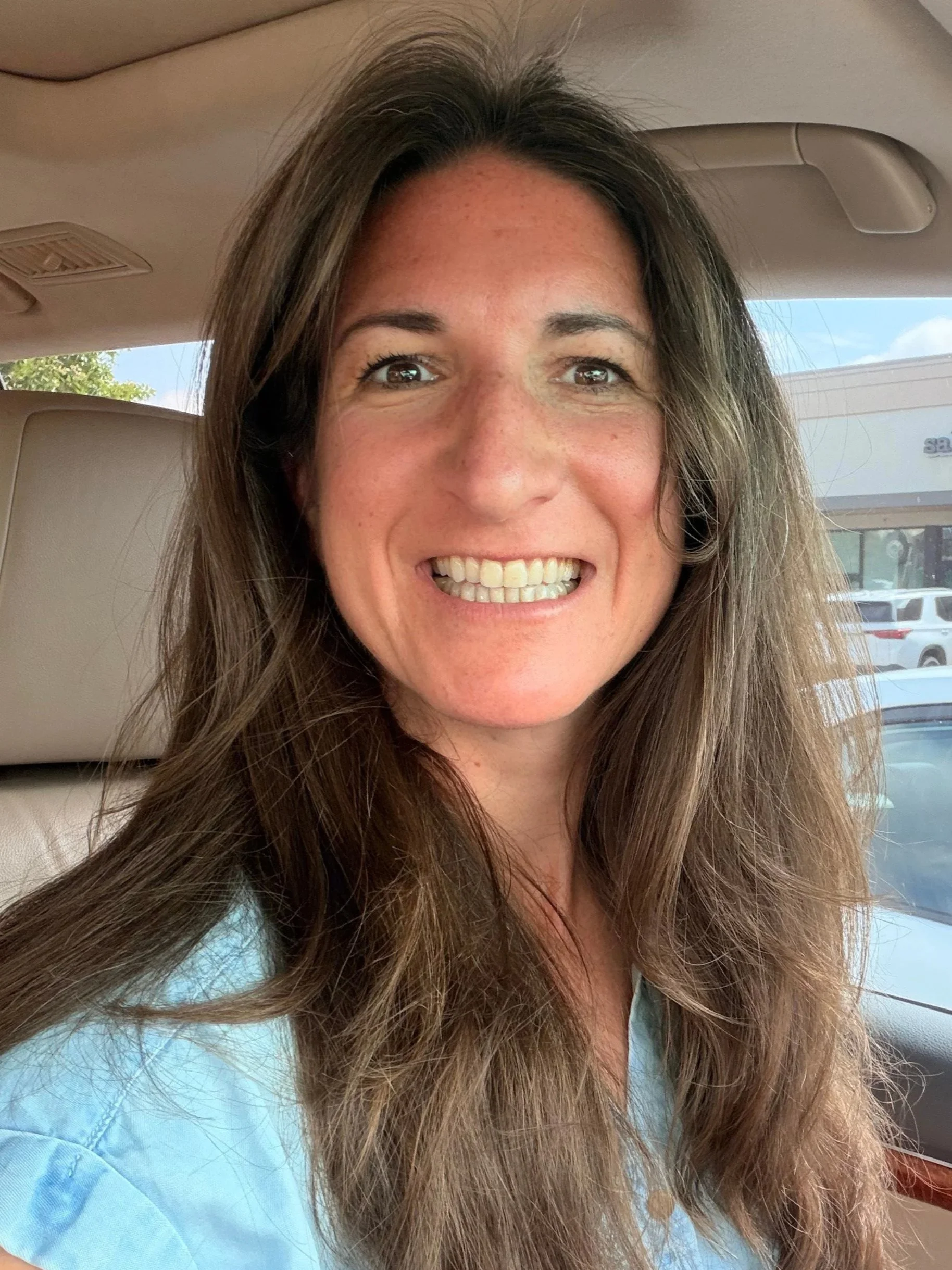 A smiling woman with brown hair