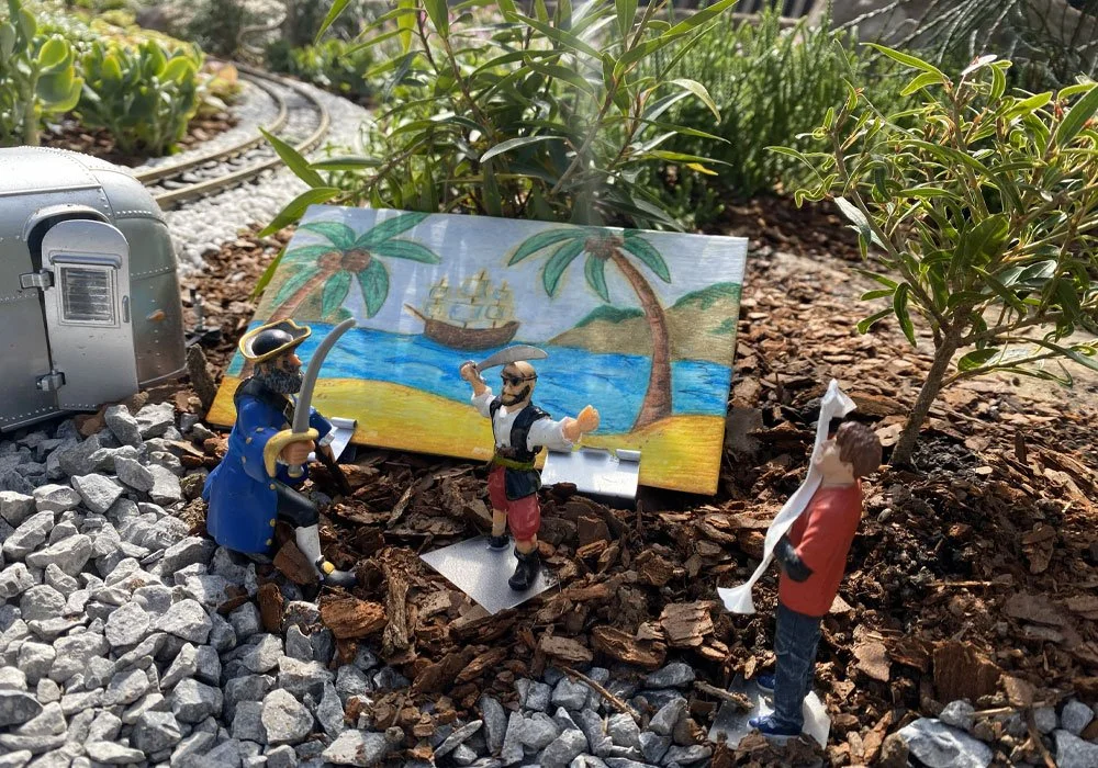 Pirate figurines in front of tropical backdrop 