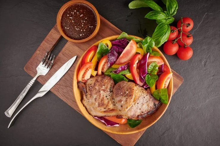 grilled-steak-with-fresh-vegetable-sweet-pepper-tomatoes-red-onion-pink-pepper-spices-home-made-tasty-food-concept-tasty-healthy-meal-black-stone-surface-pork-steak-with-salad_1150-44971.jpg