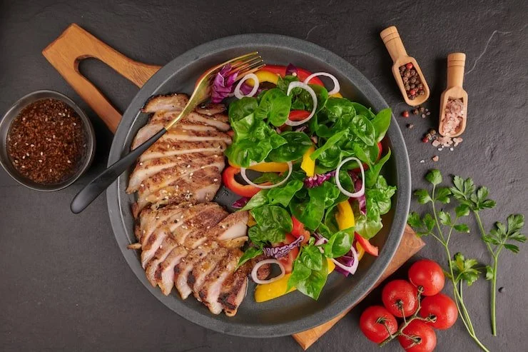 grilled-steak-with-fresh-vegetable-sweet-pepper-tomatoes-red-onion-pink-pepper-spices-home-made-tasty-food-concept-tasty-healthy-meal-black-stone-surface-pork-steak-with-salad_1150-44973.jpg