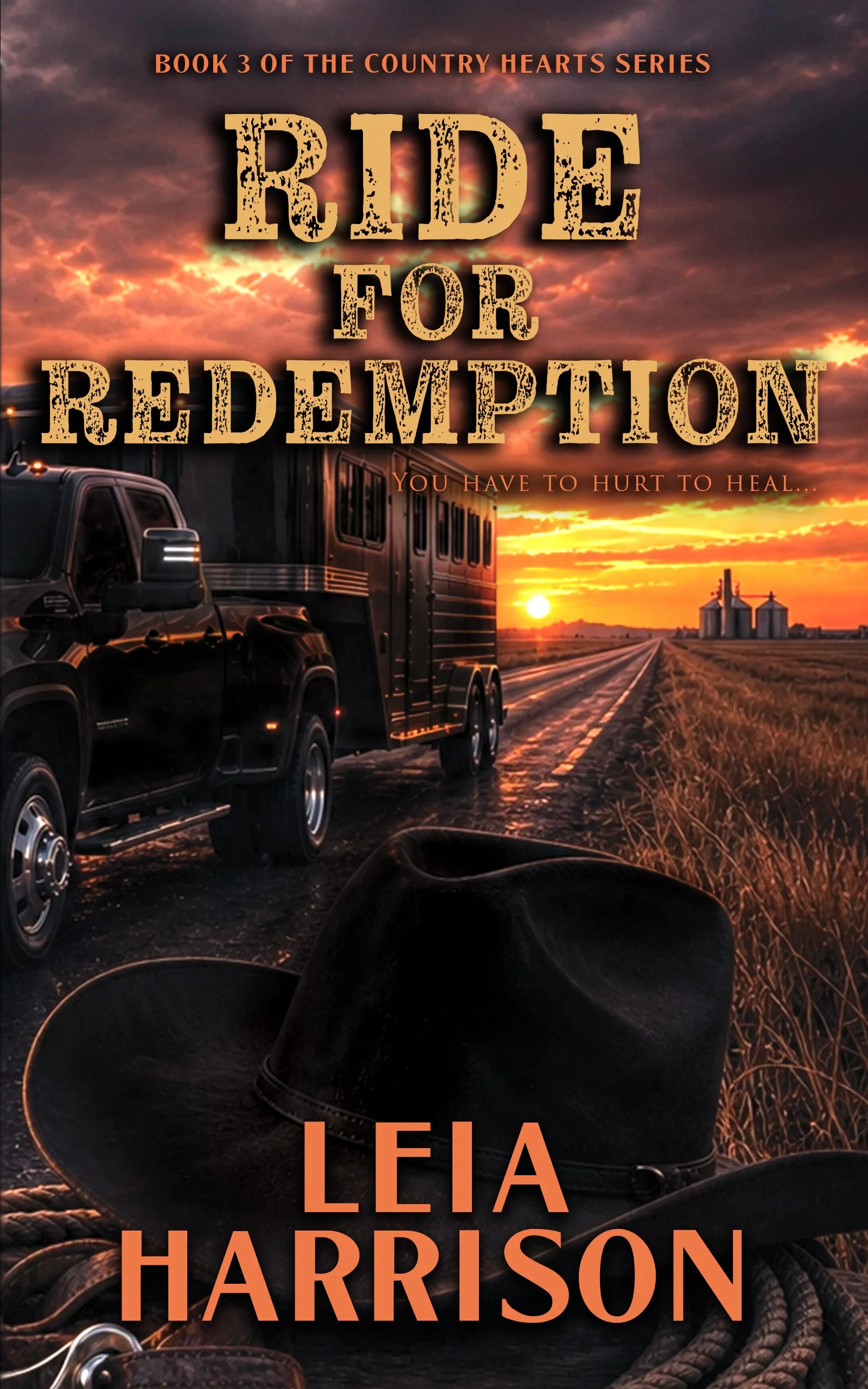 Book cover for 'Ride for Redemption' by Leia Harrison. The cover features a sunset or sunrise scene with a dark pickup truck pulling a trailer on a rural road, farm silos in the distance, and a cowboy hat and boots in the foreground. The title and author's name are prominently displayed.