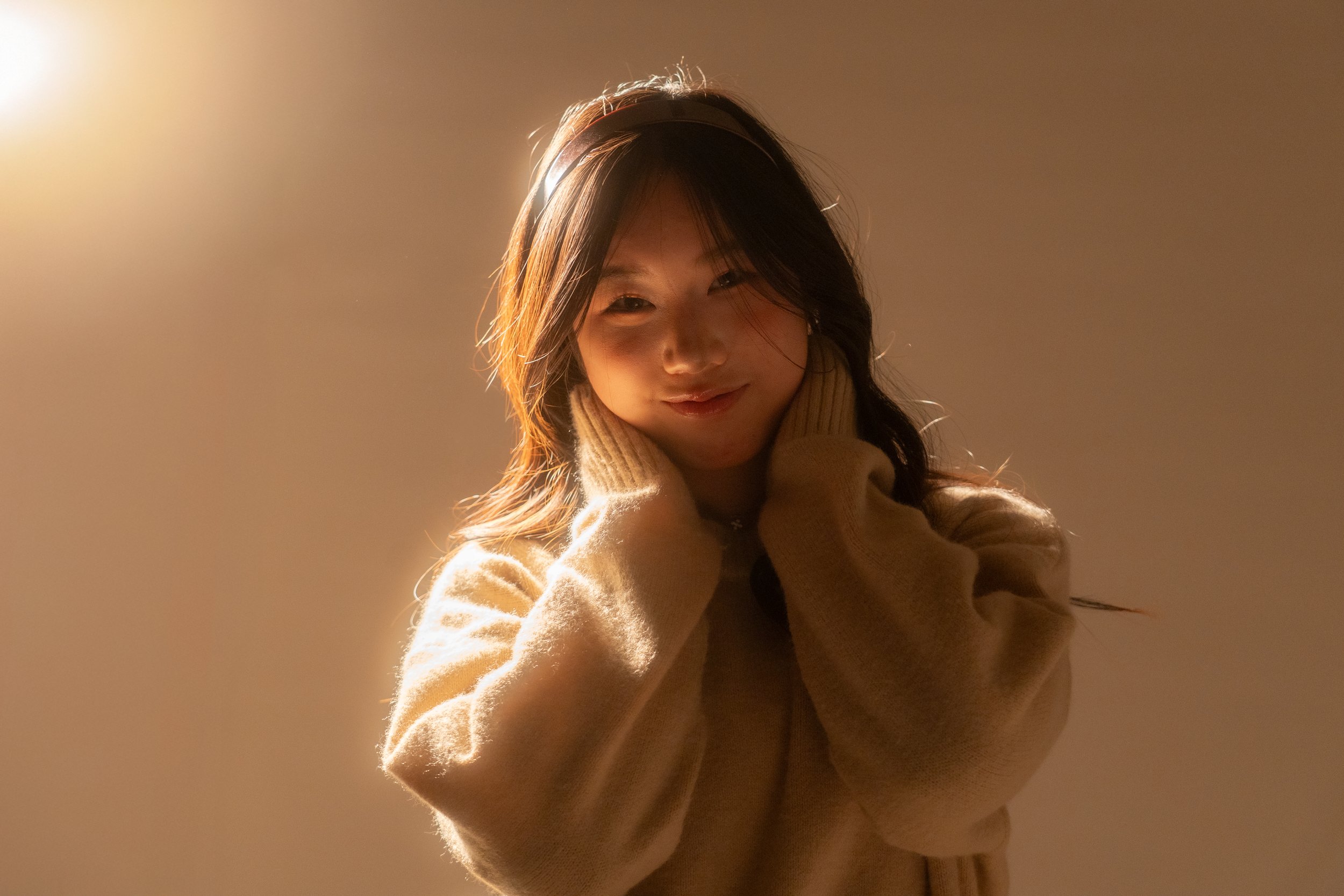 a young girl smiling under golden light