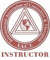 Logo of the International Association of Counselors and Therapists (I.A.C.T.), featuring a triangle with a globe inside and surrounded by the organization's name, with the word INSTRUCTOR below.