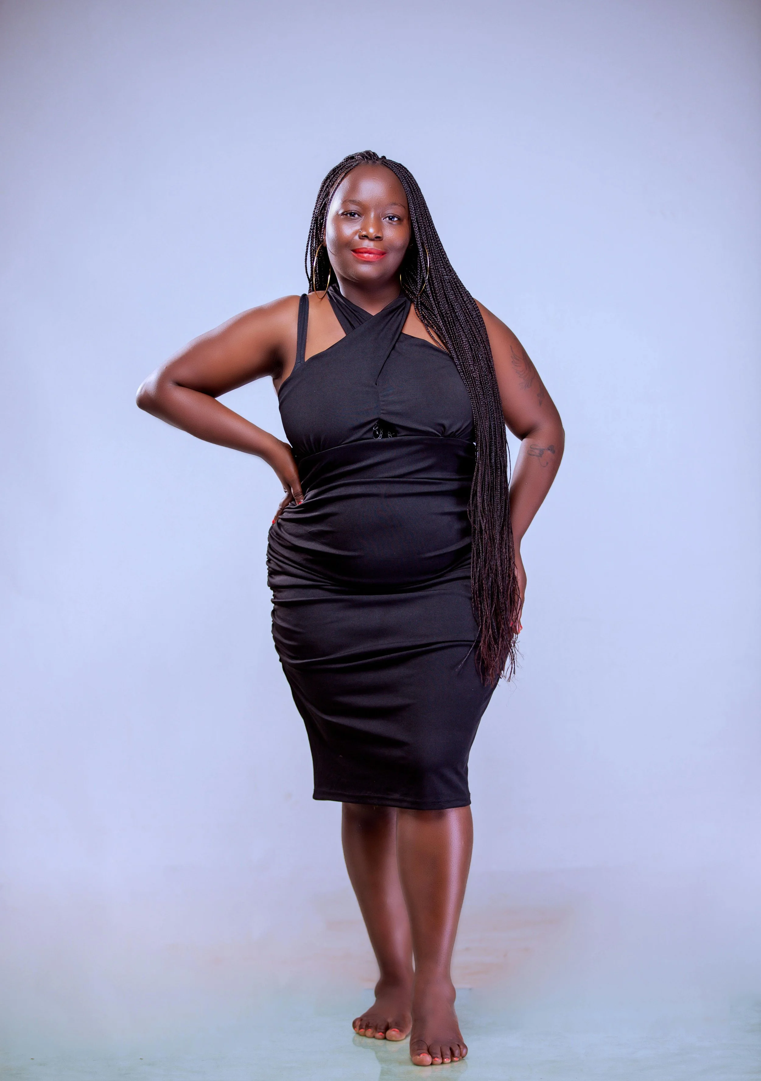 A confident woman in a black dress pictured to show us the power of hypnosis for self confidence