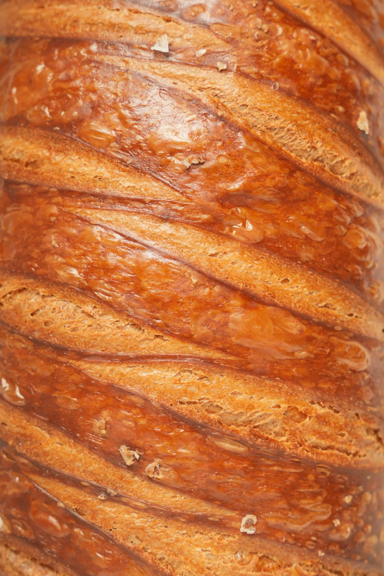 Close-up of a sliced loaf of bread with a golden brown, crispy crust.