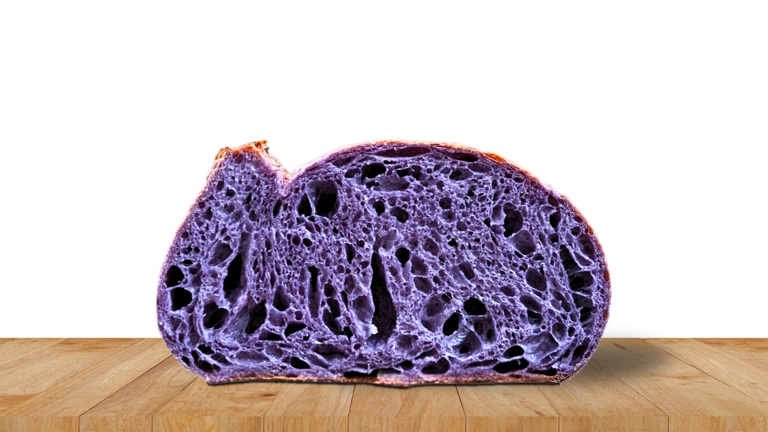 Close-up of a sliced purple bread roll with a porous texture, placed on a wooden surface against a black background.