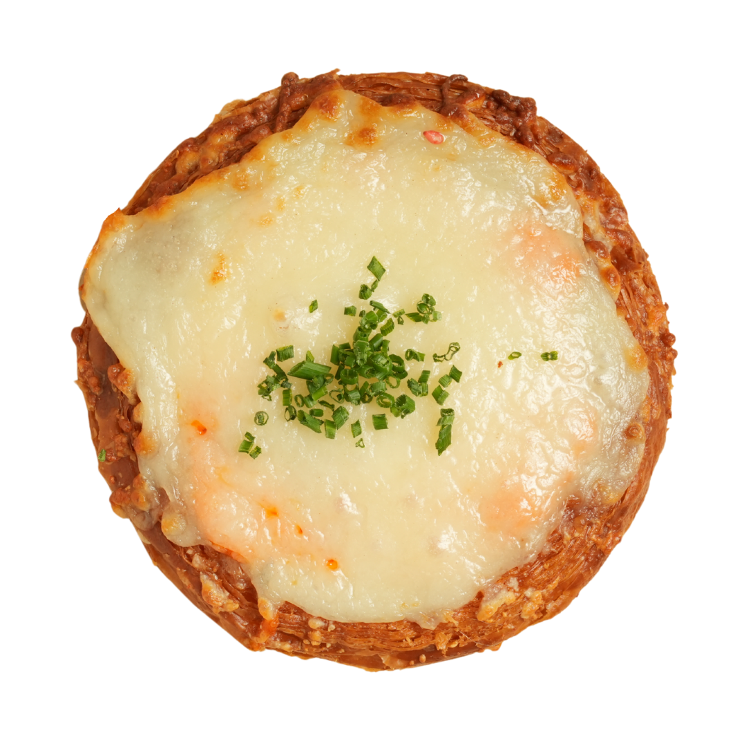 Baked dish with melted cheese and chopped herbs on top.