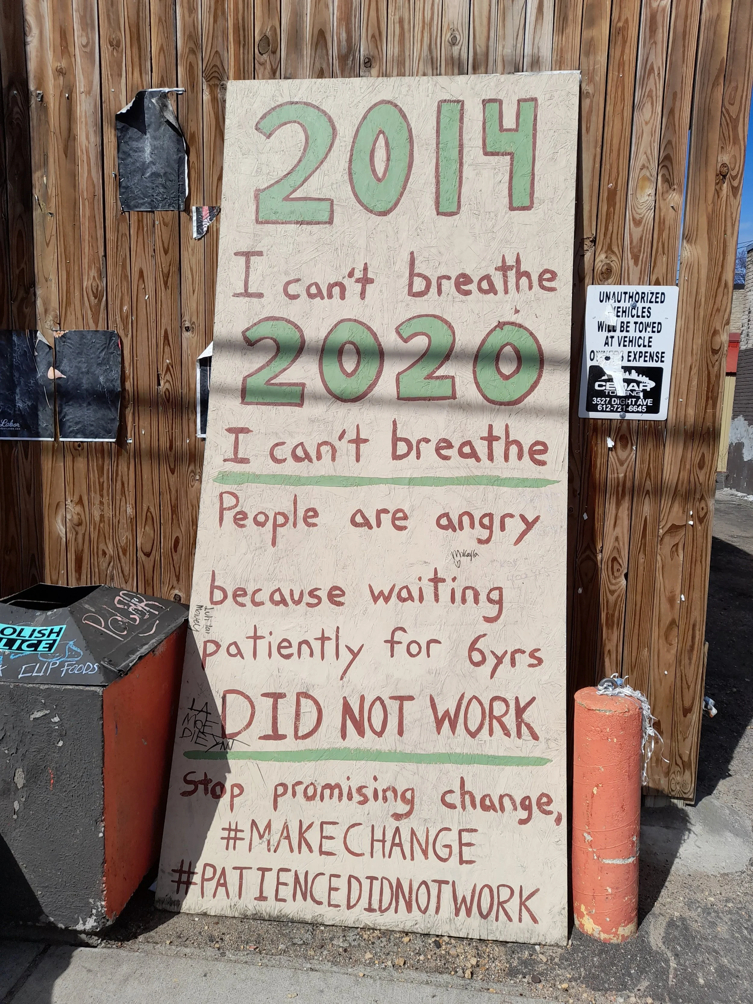 Handwritten protest sign with the years 2014 and 2020, and messages about social issues and frustration.