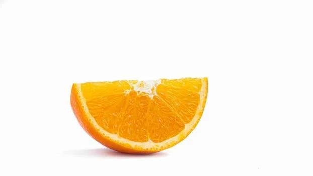 A slice of orange fruit on a white background.