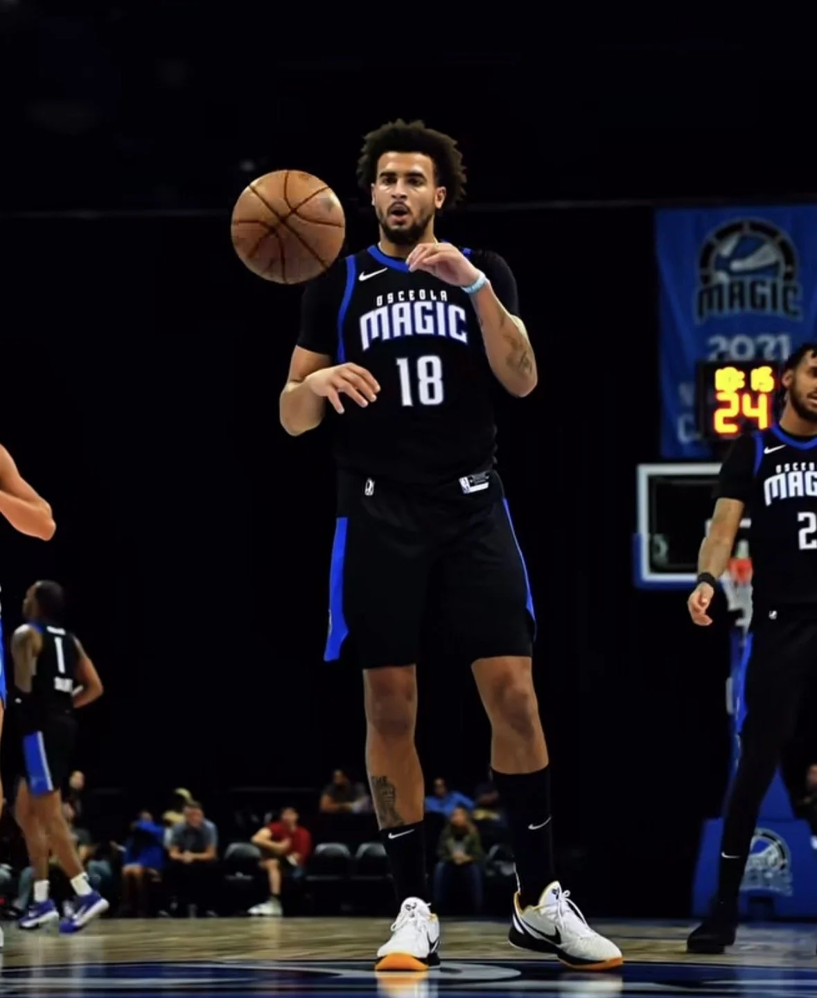 A basketball player from the Orlando Magic team wearing a black uniform with the number 18, preparing for a shot during a game.