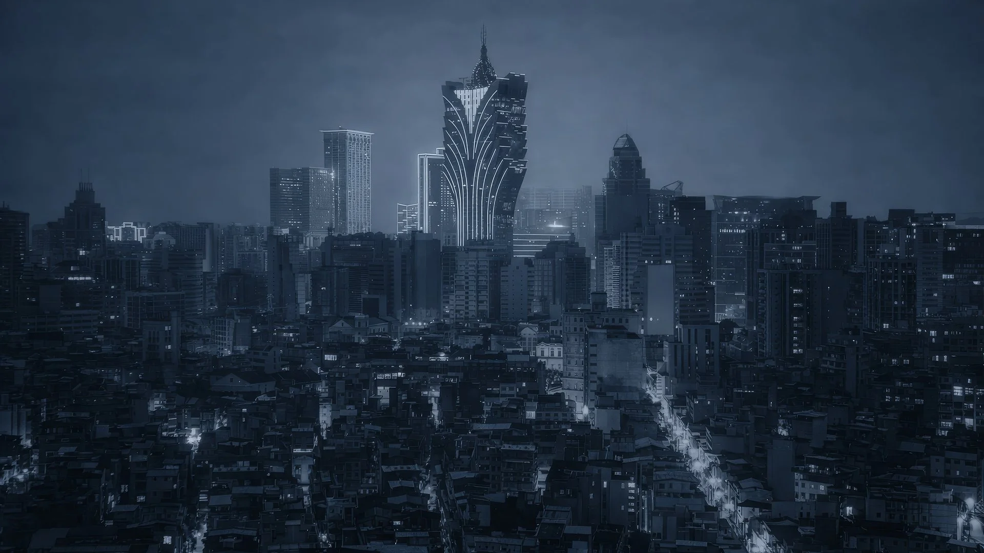 Nighttime cityscape with tall, illuminated skyscrapers, including a distinctive, modern building with sharp, curved lines at the center, and numerous smaller buildings and streets below.
