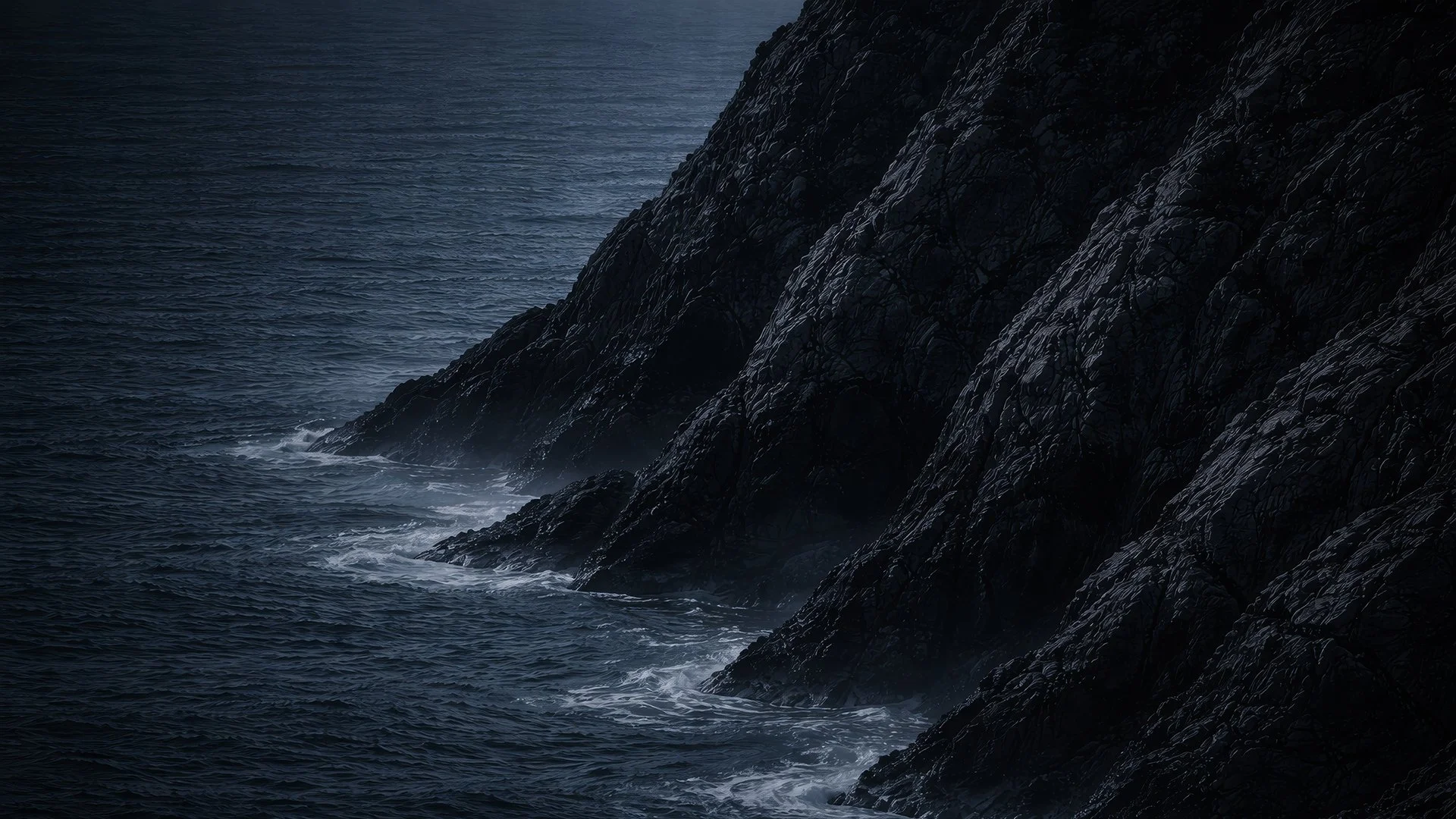Dark ocean waves hitting black rocky cliffs, moody and stormy atmosphere.