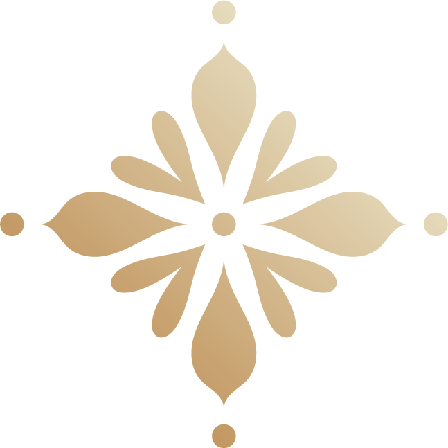 Gold decorative ornament with leaf and dot motifs, symmetrical design.