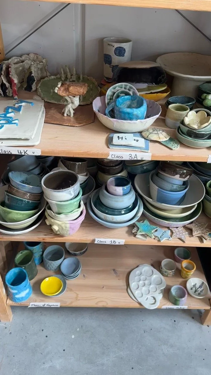 A set of shelves displaying a wide variety of student work in all colours