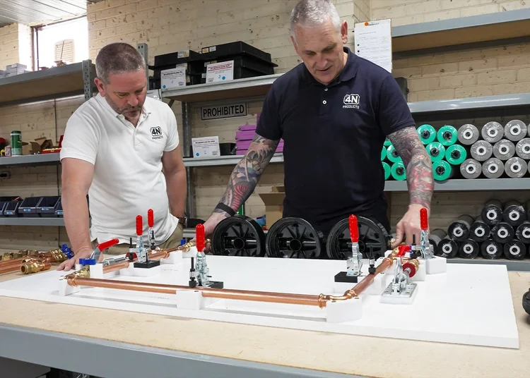 Two Cloudtap employees assembling a Cloudtap whole-home filtration system