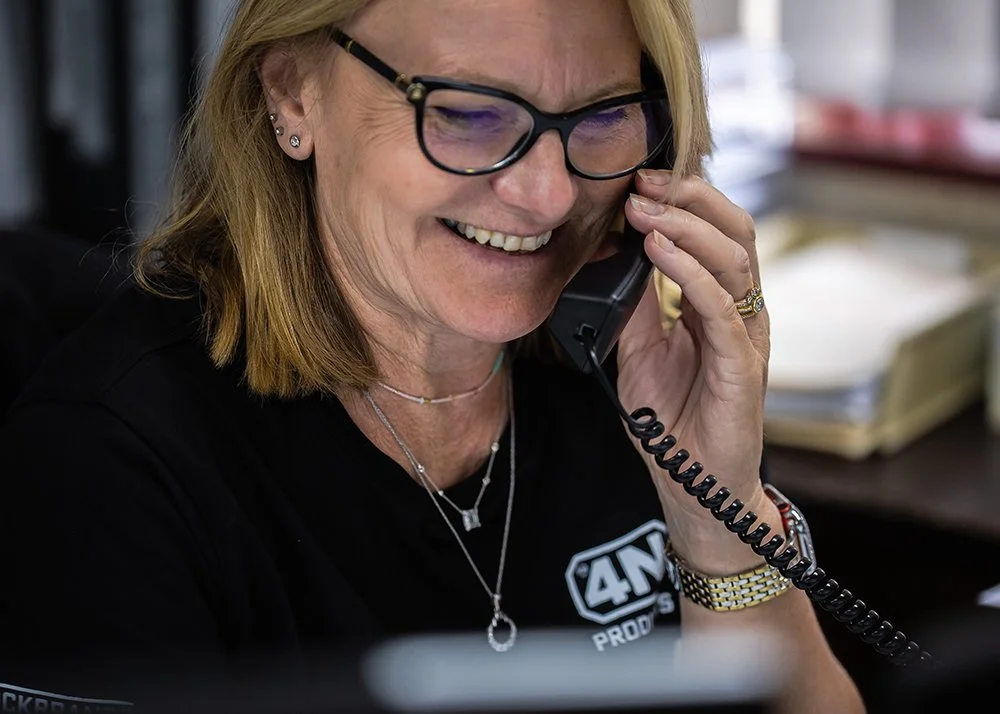 Happy 4N receptionist answering a phone call