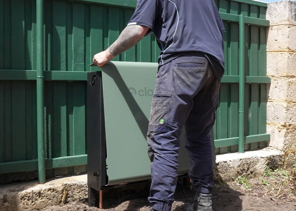 An installer placing cover over a Cloudtap Design Series unit