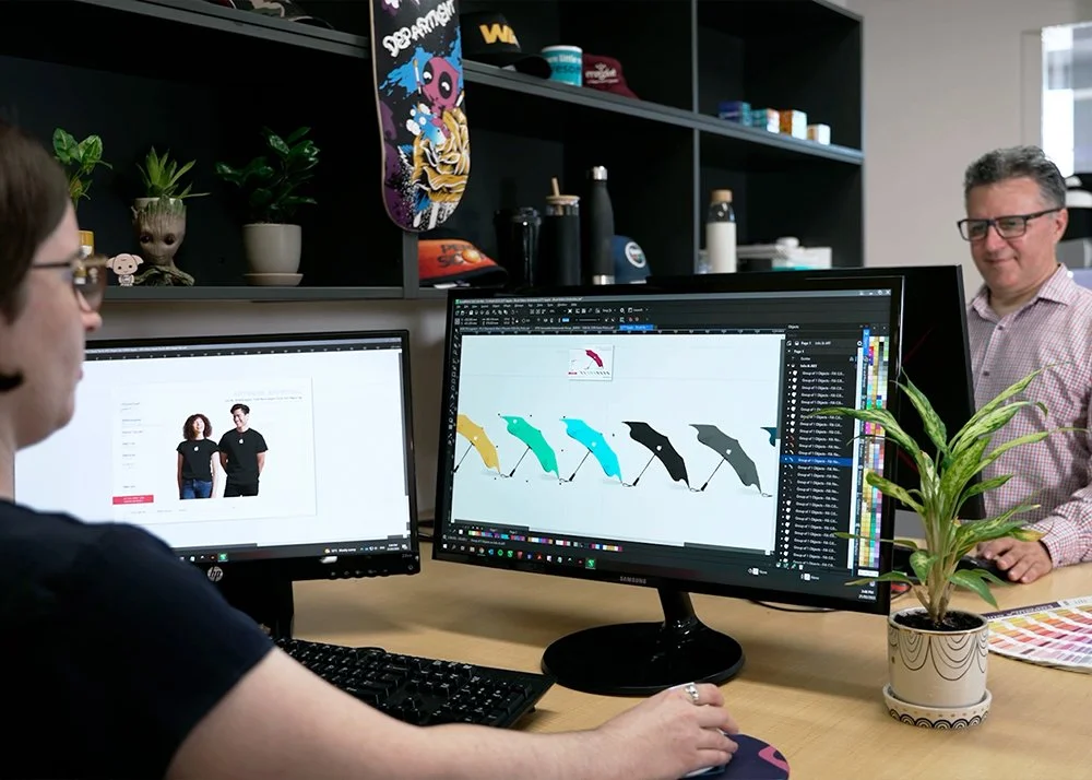 Two graphic designers working on client projects