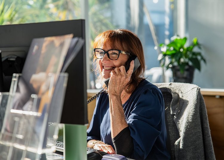 Smiling Look Brilliant receptionist answering a phone call