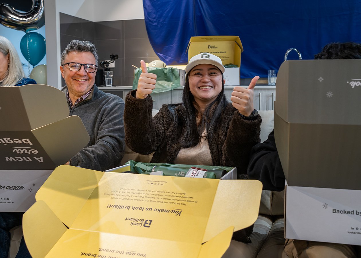 Two happy Look Brilliant employees celebrating together