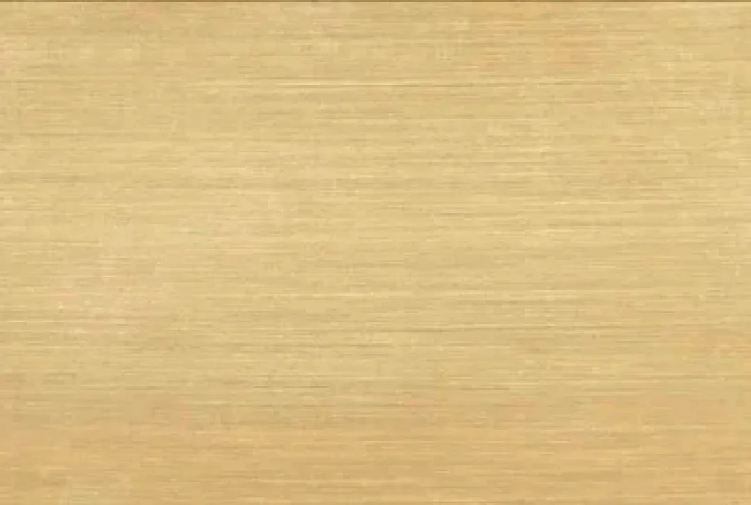 Close-up of a smooth, golden-colored metallic surface.