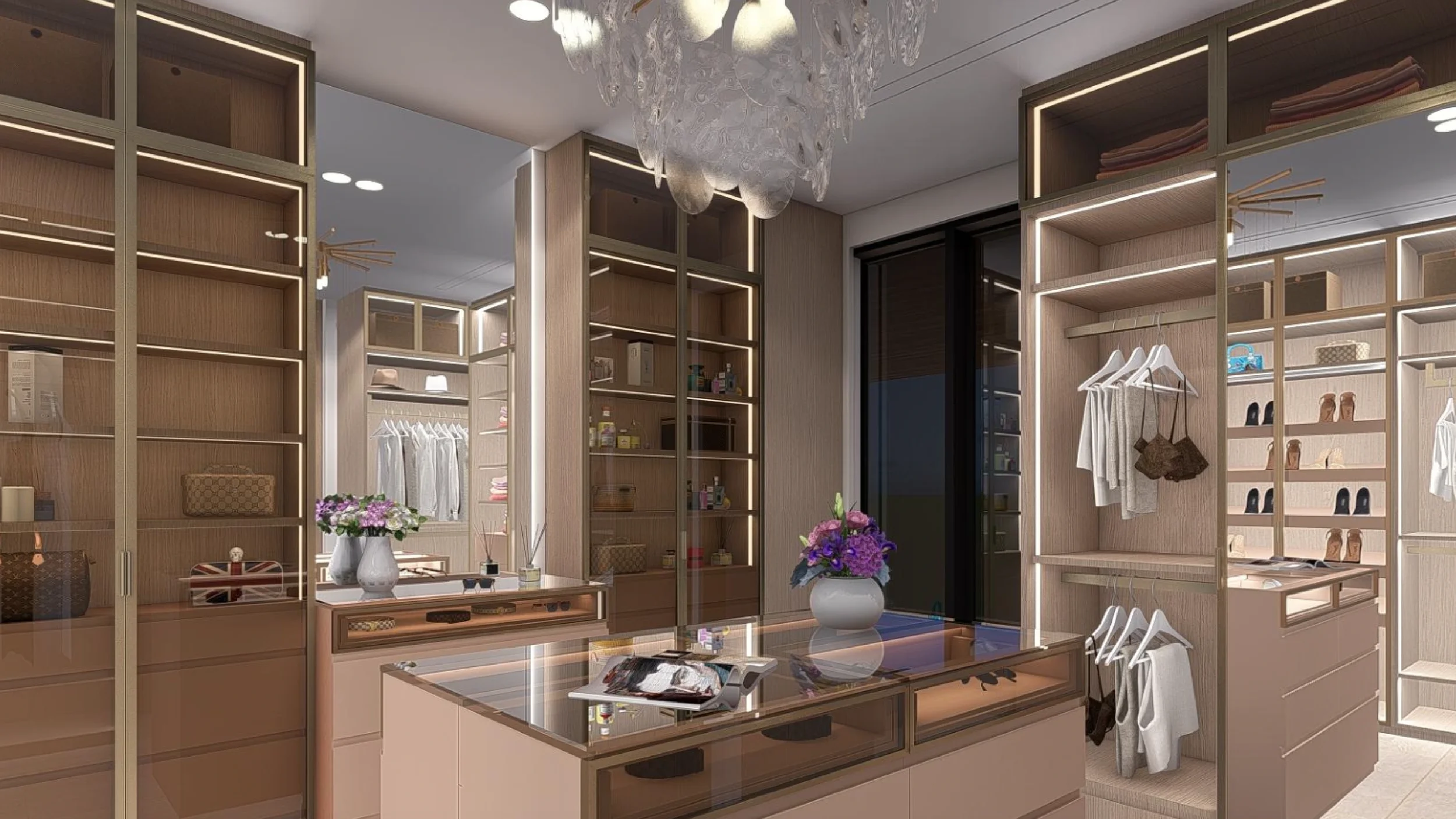 A walk-in closet with built-in shelves, hanging space, and drawers, decorated with vases of flowers and clothes, illuminated by indoor lighting and a chandelier.